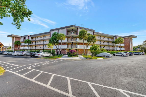 Front view of a multi-story apartment building with balconies.