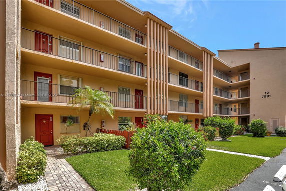 Front view of a multi-story apartment building with balconies.