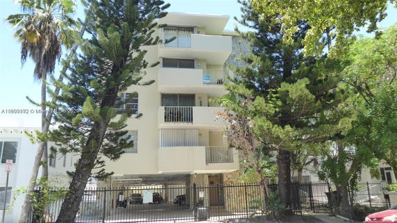 Front view of a multi-story residential building with balconies.