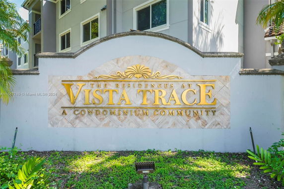 Front view of a condominium sign and building.