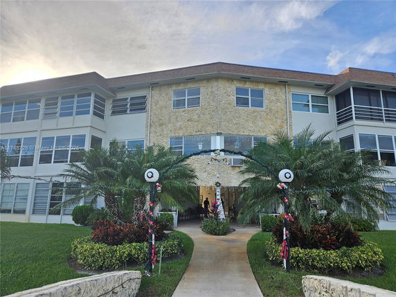Front view of a three-story residential building with a central entrance.