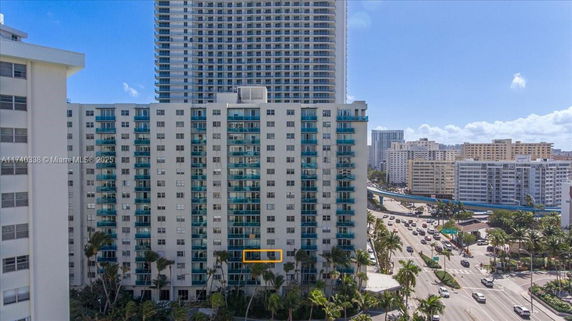 Front view of a multi-story residential building with balconies.