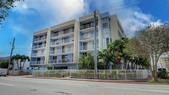 Front view of a multi-story residential building with balconies.