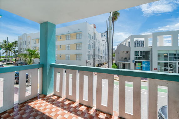 View from a balcony overlooking nearby buildings and street.