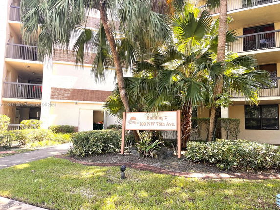 Front view of a multi-story apartment building with balconies and a sign labeled Building 2.
