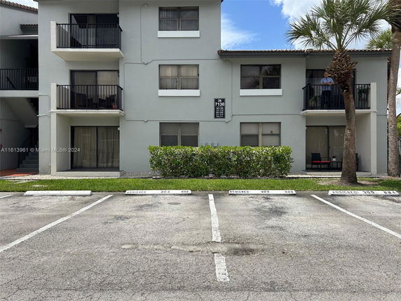 Front view of a two-story apartment building with balconies.