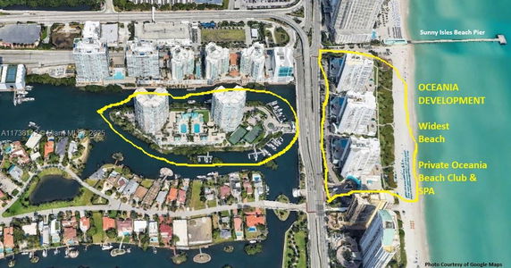 Aerial view of a coastal development with multiple high-rise buildings, surrounding waterways, and a beach.