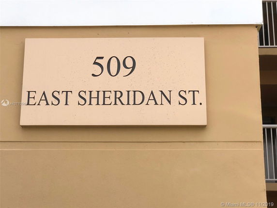 Exterior wall with building address sign reading '509 East Sheridan St.'