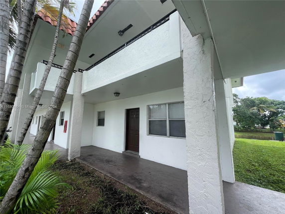 Front view of a multi-unit building with covered entryways.