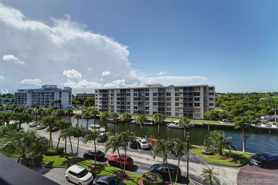 View of surrounding residential buildings and parking area near a canal.