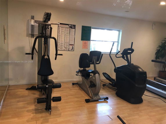 Indoor gym area with exercise equipment including a stationary bike and elliptical machine.