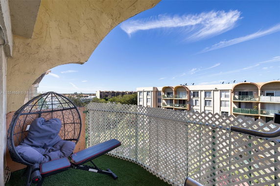 View from a balcony overlooking surrounding apartment buildings.
