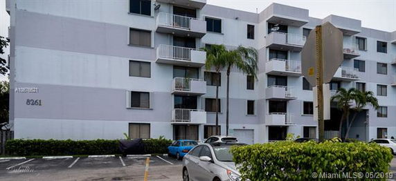 Front view of a multi-story building with balconies.