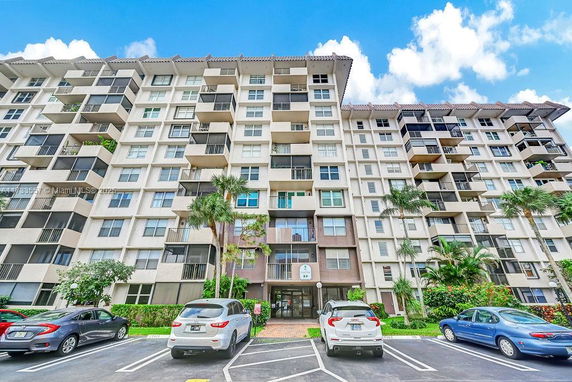 Front view of a multi-story apartment building with balconies.