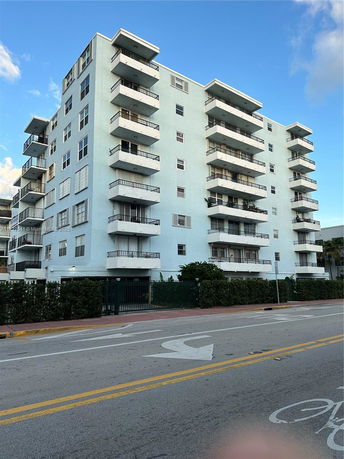 Front view of a multi-story residential building with balconies.