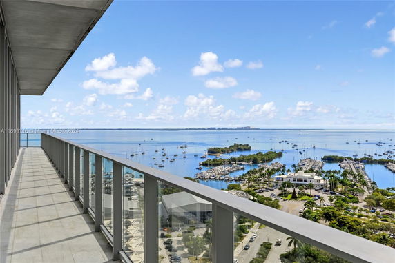 Panoramic view from a high vantage point overlooking a marina and bay area with boats.