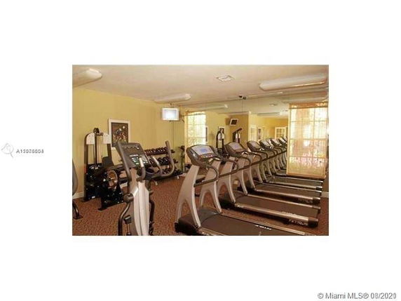 Indoor gym area with multiple treadmills and exercise equipment.