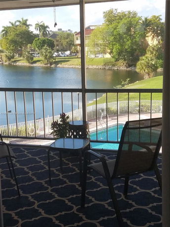 View of surrounding areas seen from the building, including a lake and greenery.