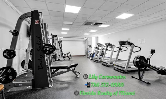 Indoor gym area with exercise equipment such as treadmills and weight machines.