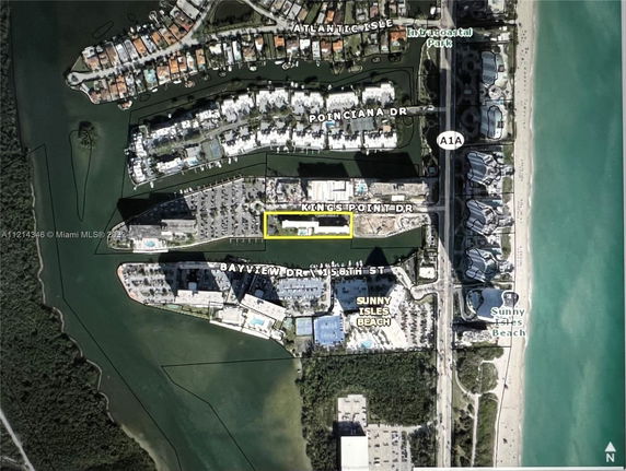 Aerial view of a coastal area with residential buildings and waterways.