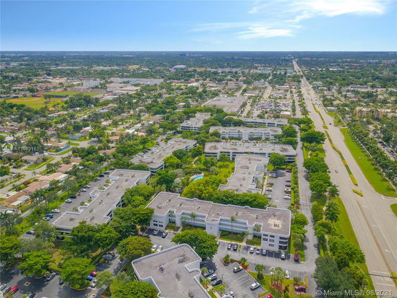 Aerial view of a suburban area with multiple office buildings and streets surrounded by greenery.