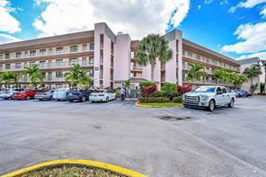 Outdoor parking area in front of a multi-story building.