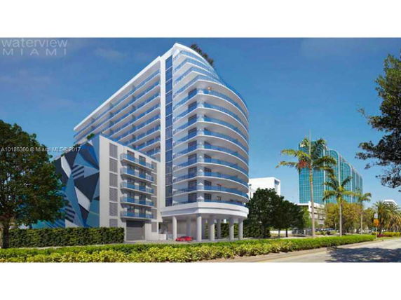Front view of a modern multi-story residential building with rounded balconies.