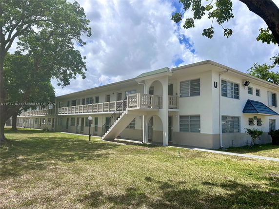 Front view of a two-story apartment building with external staircases.