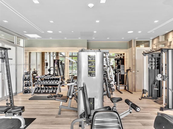 Interior view of a fitness room with various gym equipment and weights.