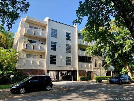Front view of a multi-story apartment building with balconies.