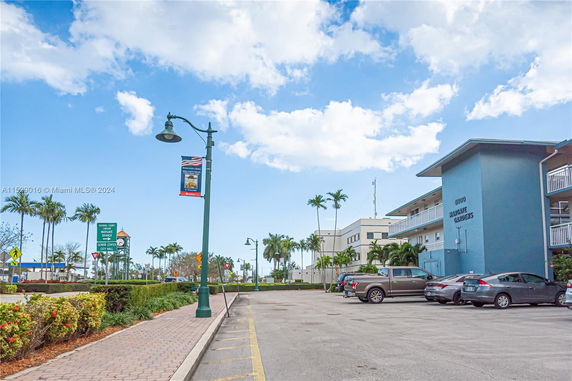 Outdoor parking area in front of a multi-story building