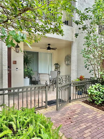 Front view of a house with a covered patio area and outdoor seating.