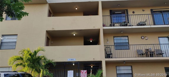 Exterior view of a multi-story apartment building with balconies.