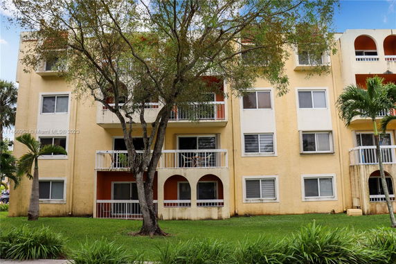 Front view of a multi-story apartment building with balconies.