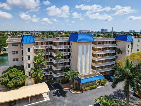 Front view of a multi-story building with blue pyramid-shaped roof structures.