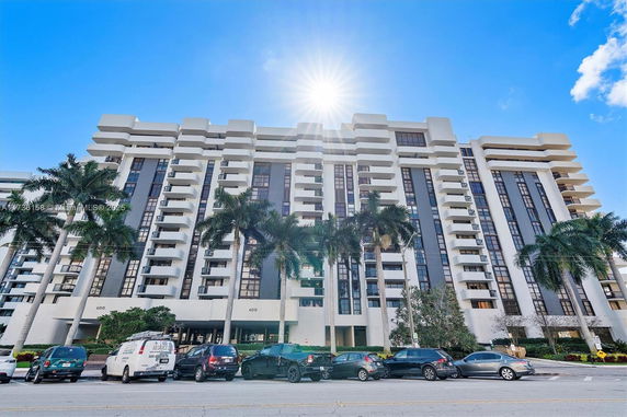 Front view of a multi-story residential building with balconies.