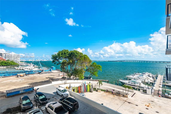 View of a waterfront area with boats docked and clear blue sky.