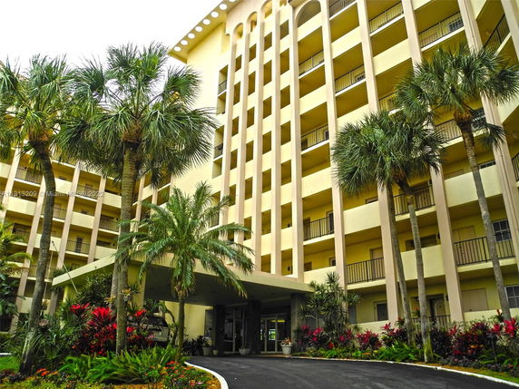 Front view of a multi-story residential building with balconies.