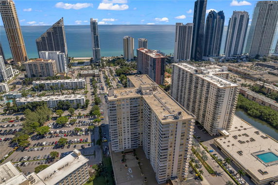 Aerial view of high-rise buildings and ocean in the background.