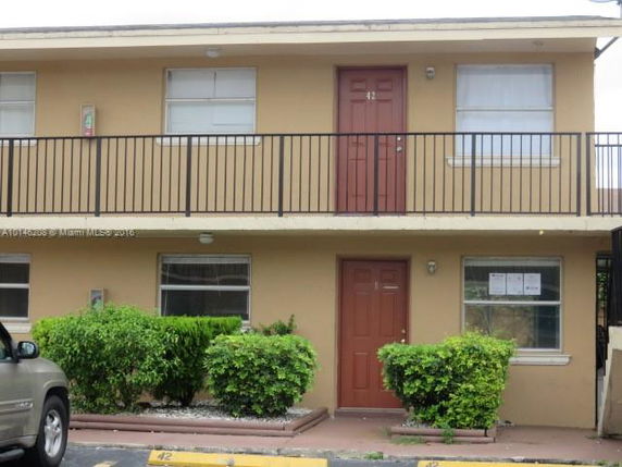 Front view of a two-story building with balconies.