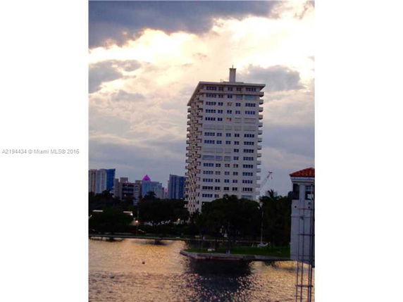 View of a high-rise building near a waterfront.