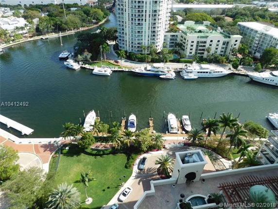 Panoramic view of waterfront buildings and docked boats.