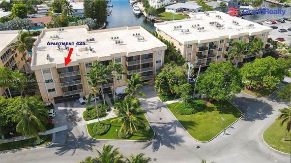 Elevated view of a multi-story apartment building with a flat roof.