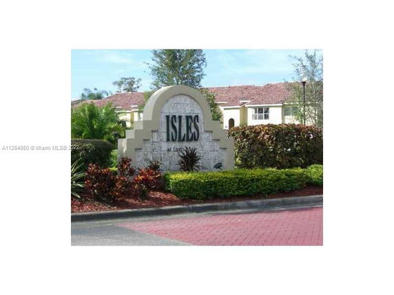 Entrance sign of a residential community with landscaping.