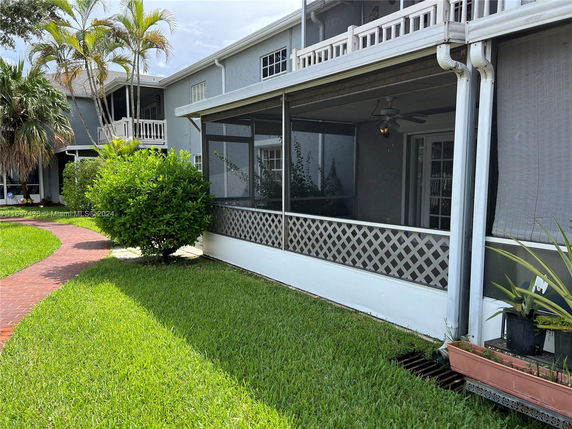 Front view of a two-story house with a screened porch.