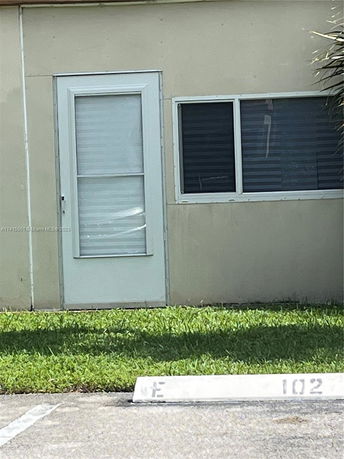 Front view of a house exterior with a door and a window.