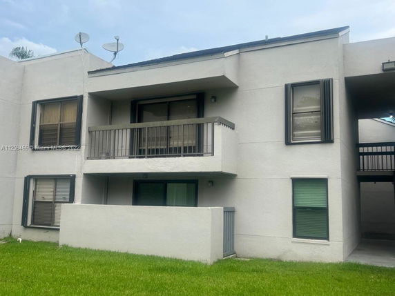 Front view of a multi-story building with balconies.