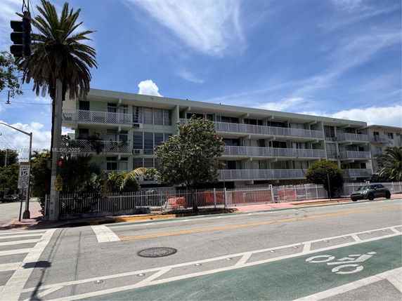 Front view of a multi-story residential building with balconies.