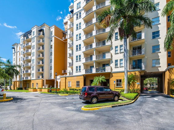 Front view of a multi-story residential building with balconies.