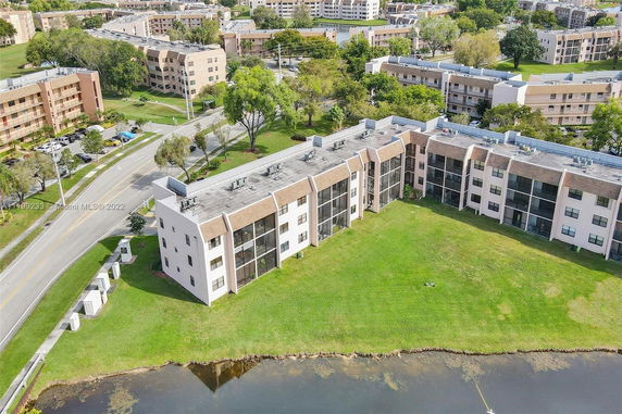 Aerial view of a residential complex with multiple buildings and green spaces.